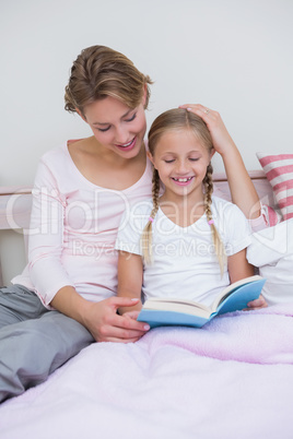 Mother with her daughter at bedtime