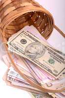 european money on wooden basket, hryvnia, dollars, euro