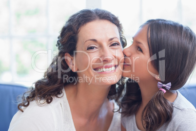 Cute girl kissing her smiling mother
