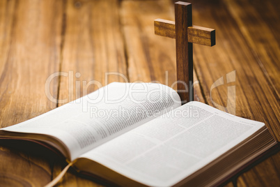 Open bible with crucifix icon behind