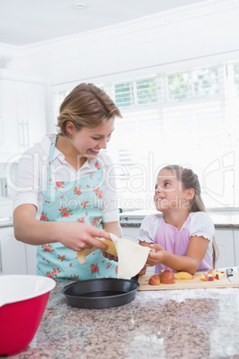 Mother and daughter baking together