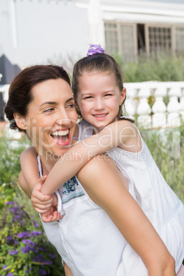 Mother and daughter smiling at camera