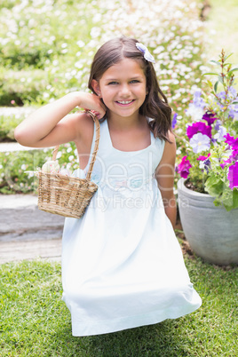 Happy girl collecting easter eggs