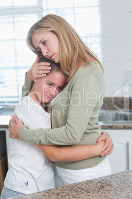Sad little girl hugging her mother