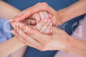 Mother and daughter touching hands