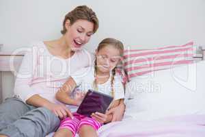 Mother and daughter using tablet pc