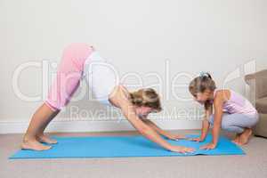 Mother and daughter doing yoga