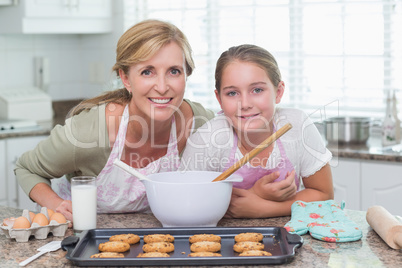 Mother and daughter making cookies together