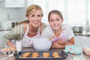 Mother and daughter making cookies together