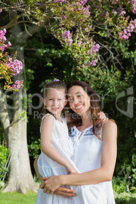 Mother and daughter smiling at camera