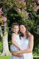 Mother and daughter smiling at camera