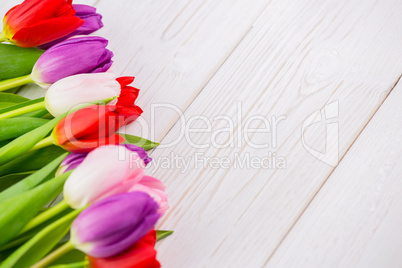 Colorful tulips on wooden table