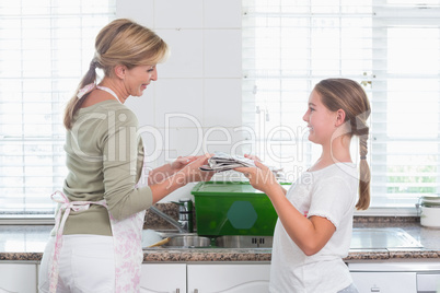 Mother and daughter recycling together