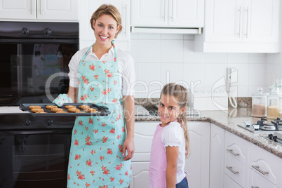 Mother and daughter with hot fresh cookies