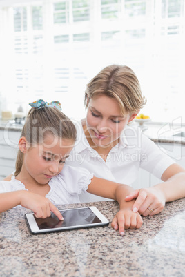 Mother and daughter using tablet pc