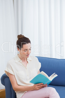 Casual woman reading on the couch