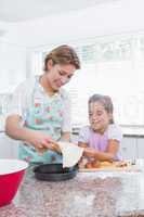 Mother and daughter baking together