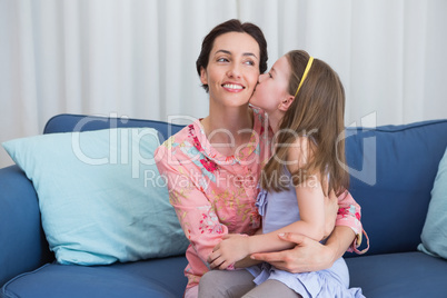 Little girl kissing her mother