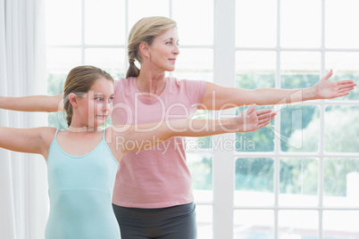 Mother and daughter doing yoga