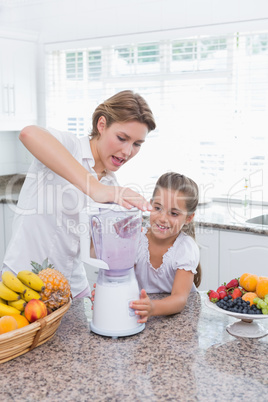 Mother and daughter making a smoothie