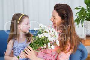 Daughter surprising mother with flowers