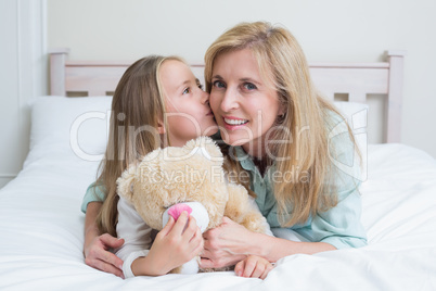 Cute girl kissing her smiling mother