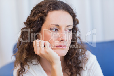 Worried woman sitting on the couch