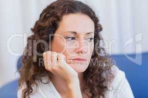 Worried woman sitting on the couch