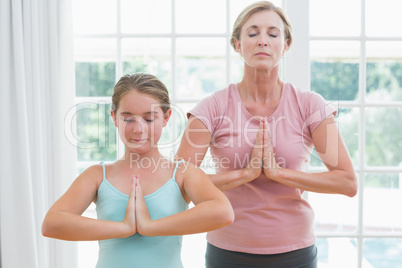 Mother and daughter doing yoga