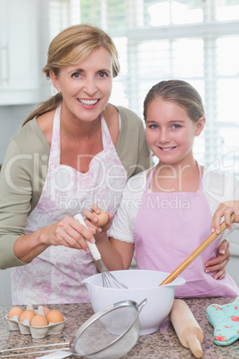 Mother and daughter making cake together