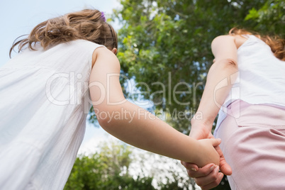 Mother and daughter holding hands