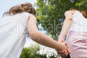 Mother and daughter holding hands