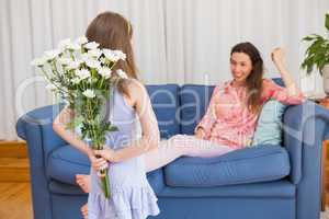 Daughter surprising mother with flowers