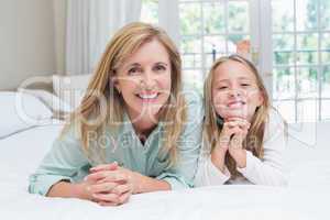 Happy mother and daughter smiling at camera