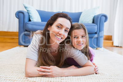 Mother and daughter smiling at camera