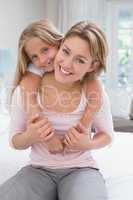 Mother and daughter smiling at camera