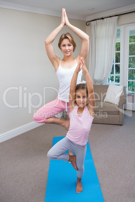 Mother and daughter doing yoga