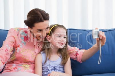 Mother and daughter taking selfie