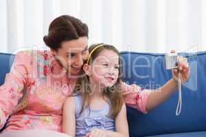 Mother and daughter taking selfie