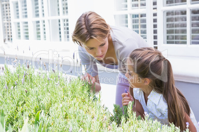 Mother and daughter tending to flowers