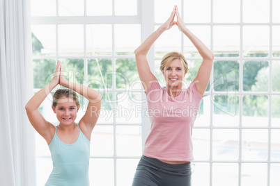 Mother and daughter doing yoga