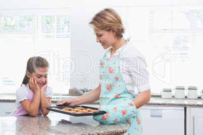 Mother and daughter with hot fresh cookies