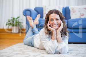 Smiling woman lying on the floor