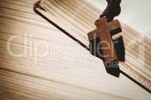 Open bible and wooden rosary beads