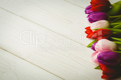 Colorful tulips on wooden table