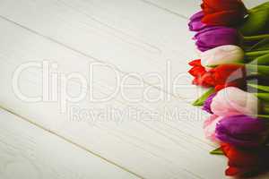 Colorful tulips on wooden table