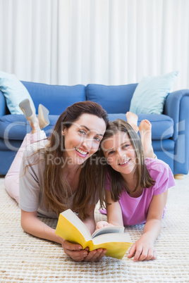 Mother and daughter reading on the floor