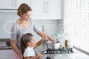 Mother and daughter cooking together