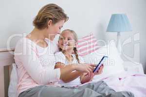 Mother and daughter using tablet pc