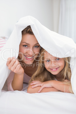 Mother and daughter smiling at camera